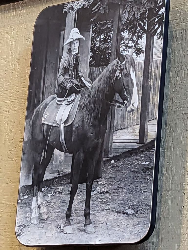old photo of a white woman on a horse